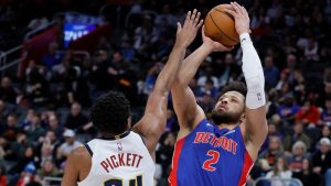 Detroit Pistons guard Cade Cunningham (2) takes a shot against Denver Nuggets guard Jalen Pickett (24) during the first half of an NBA basketball game, Tuesday, Feb. 3, 2026, in Detroit. (AP Photo/Duane Burleson)