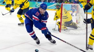 United States' Matthew Tkachuk (19) and Sweden's Gustav Forsling (42) battle for the puck during the second period of a men's ice hockey quarterfinal game at the 2026 Winter Olympics, in Milan, Italy, Wednesday, Feb. 18, 2026. (Hassan Ammar/AP)