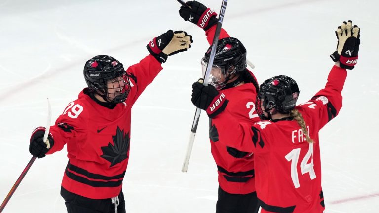Canada's Marie-Philip Poulin (29) celebrates with Sophie Jaques (2) and Renata Fast (14) after Poulin scored a goal against Switzerland during the second period of a women's ice hockey semifinal match at the 2026 Winter Olympics, in Milan, Italy, Monday, Feb. 16, 2026. (Carolyn Kaster/AP)