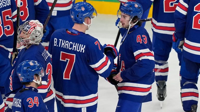 United States' Quinn Hughes (43) celebrates with Brady Tkachuk (7) after Hughes scored the winning goal in overtime to beat Sweden in a men's ice hockey quarterfinal game at the 2026 Winter Olympics, in Milan, Italy, Wednesday, Feb. 18, 2026. (Hassan Ammar/AP)