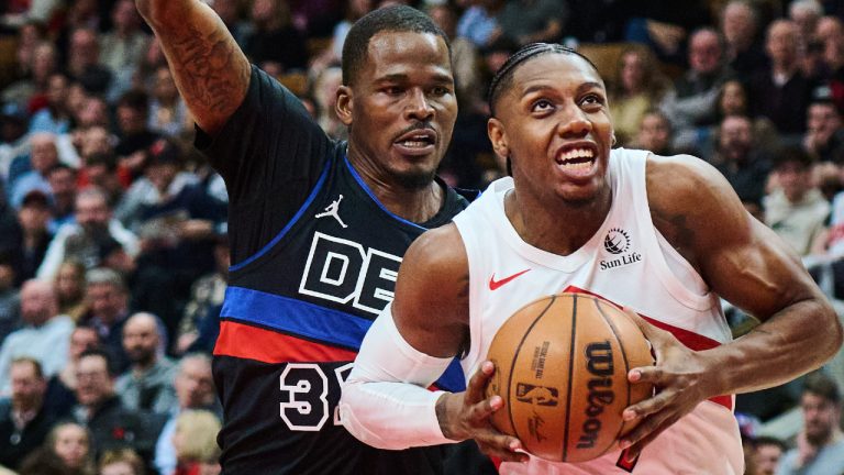 Toronto Raptors' RJ Barrett (9) drives through Detroit Pistons' Javonte Green (31) during first half NBA basketball action in Toronto, on Wednesday, Feb. 11, 2026. (Sammy Kogan/CP)