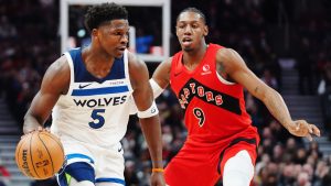 Minnesota Timberwolves' Anthony Edwards (5) protects the ball from Toronto Raptors' RJ Barrett (9) during first half NBA basketball action in Toronto on Wednesday, Feb. 4, 2026. (Frank Gunn/CP)