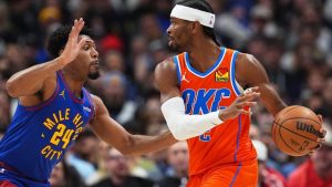 Oklahoma City Thunder guard Shai Gilgeous-Alexander, right, looks to pass the ball as Denver Nuggets guard Jalen Pickett defends in the first half of an NBA game Sunday, Feb. 1, 2026, in Denver. (AP/David Zalubowski)