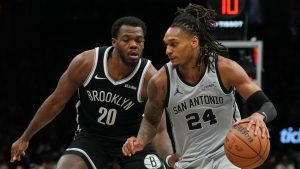 Brooklyn Nets' Day'ron Sharpe (20) defends San Antonio Spurs' Devin Vassell (24) during the second half of an NBA basketball game Thursday, Feb. 26, 2026, in New York. (AP Photo/Frank Franklin II)