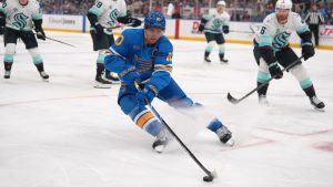 St. Louis Blues' Brayden Schenn (10) handles the puck as Seattle Kraken's Eeli Tolvanen, left, Vince Dunn (29) and Adam Larsson (6) defend during the second period of an NHL hockey game Saturday, Nov. 8, 2025, in St. Louis. (Jeff Roberson/AP)