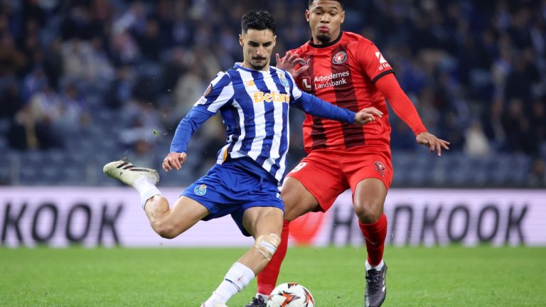 Porto's Stephen Eustaquio takes a shot next to Midtjylland's Pedro Bravo, right, during the Europa League opening phase match between FC Porto and FC Midtjylland at the Dragao stadium in Porto, Portugal, Thursday, Dec. 12, 2024. (AP/Luis Vieira)
