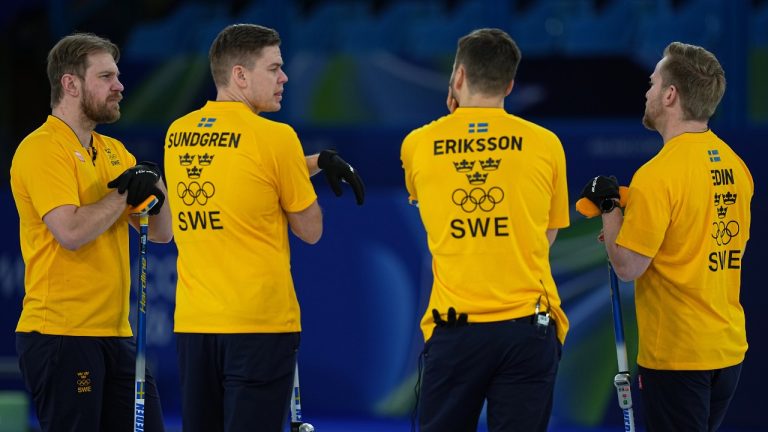 Sweden's Rasmus Wranaa, Christoffer Sundgren, Oskar Eriksson, and Niklas Edin strategize during the men's curling round robin session against Britain at the 2026 Winter Olympics, in Cortina d'Ampezzo, Italy, Thursday, Feb.12, 2026. (Fatima Shbair/AP)