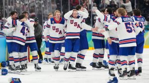 The United States celebrates winning during a men's ice hockey gold medal game between Canada and the United States at the 2026 Winter Olympics, in Milan, Italy, Sunday, Feb. 22, 2026. (Hassan Ammar/AP)