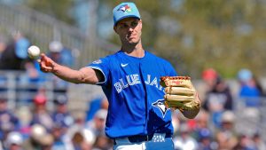 Toronto Blue Jays pitcher Tyler Rogers throws the ball to first base in time to get New York Yankees' Austin Wells out during the third inning of a spring training baseball game Tuesday, Feb. 24, 2026, in Dunedin, Fla. (Chris O'Meara/AP)