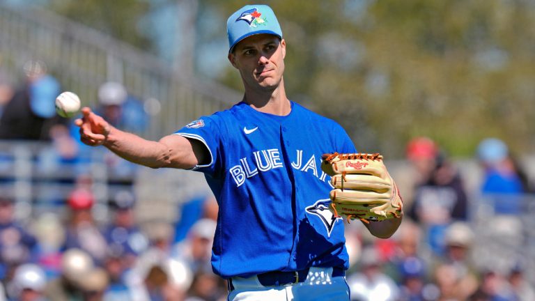 Toronto Blue Jays pitcher Tyler Rogers throws the ball to first base in time to get New York Yankees' Austin Wells out during the third inning of a spring training baseball game Tuesday, Feb. 24, 2026, in Dunedin, Fla. (Chris O'Meara/AP)