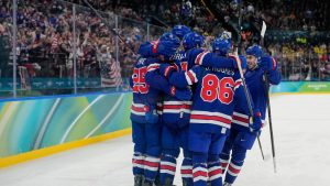 United States' Dylan Larkin (21) is congratulated after scoring a goal against Sweden during the second period of a men's ice hockey quarterfinal game at the 2026 Winter Olympics, in Milan, Italy, Wednesday, Feb. 18, 2026. (Hassan Ammar/AP)