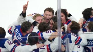 United States players celebrate after defeating Canada 2-1 in overtime to win the men's ice hockey gold medal game at the 2026 Winter Olympics in Milan, Italy, Sunday, Feb. 22, 2026. (Carolyn Kaster/AP)