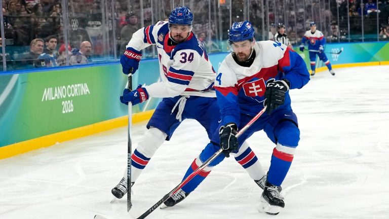 United States' Auston Matthews (34) challenges with Slovakia's Peter Ceresnak (14) during a men's ice hockey semifinal game between the United States and Slovakia at the 2026 Winter Olympics, in Milan, Italy, Friday, Feb. 20, 2026. (Hassan Ammar/AP)