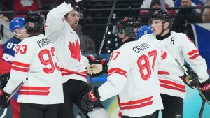 Mark Stone (61) of Team Canada celebrates a goal with Mitch Marner (93), Sidney Crosby (87) and Cale Makar (8) of Team Canada during second period men's Olympic hockey action at the 2026 Milan Cortina Winter Olympics in Milan, Italy on Thursday, February 12, 2026. THE CANADIAN PRESS/Nathan Denette