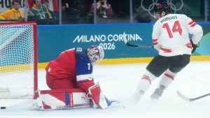 Bo Horvat of Team Canada scores past Lukas Dostal of Team Czechia during second period action at the 2026 Milan Cortina Winter Olympics in Milan, Italy, on Thursday, Feb. 12, 2026. (CP/Nathan Denette)