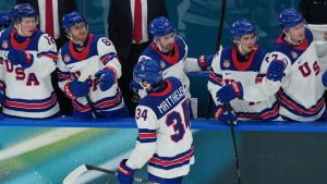 United States' Auston Matthews celebrates with teammates after scoring his sides fifth goal during a preliminary round match of men's ice hockey between Latvia and the United States at the 2026 Winter Olympics, in Milan, Italy, Thursday, Feb. 12, 2026. (AP Photo/Carolyn Kaster)
