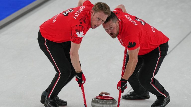 Canada's Marc Kennedy and Ben Hebert in action during the men's curling round robin session against Britain at the 2026 Winter Olympics, in Cortina d'Ampezzo, Italy, Tuesday, Feb. 17, 2026. (AP Photo/Fatima Shbair)