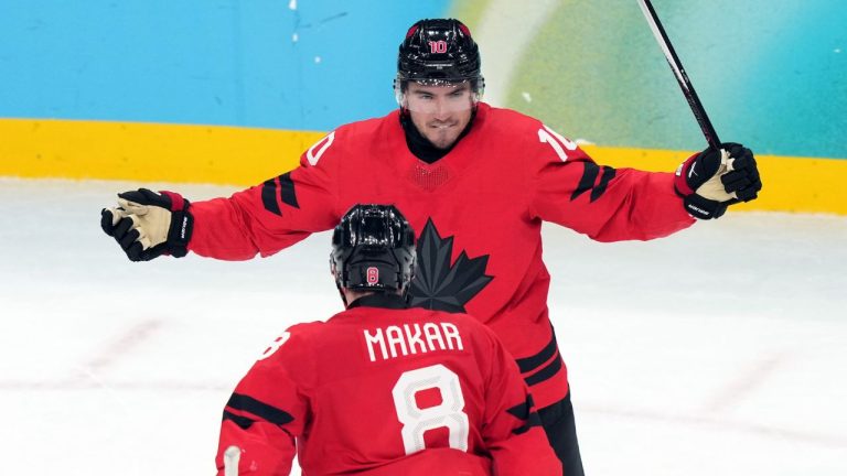 Canada's Nick Suzuki celebrates with Cale Makar (8) after Suzuki scored a goal against Czechia during the third period of a men's ice hockey quarterfinal game at the 2026 Winter Olympics, in Milan, Italy, Wednesday, Feb. 18, 2026. (AP Photo/Carolyn Kaster)