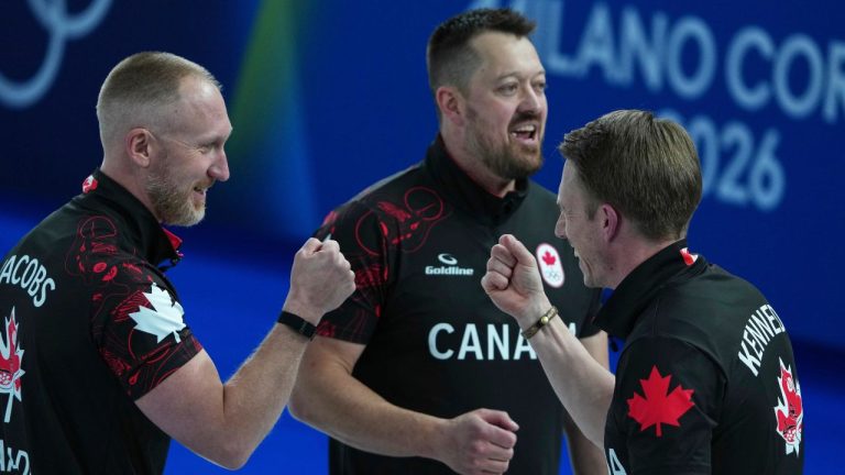 Canada's Marc Kennedy, Brad Jacobs, and Ben Hebert react after the men's curling round robin session against Sweden, at the 2026 Winter Olympics, in Cortina d'Ampezzo, Italy, Friday, Feb. 13, 2026. (AP Photo/Misper Apawu)