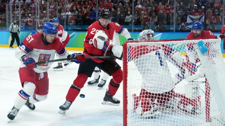 Czechia goalie Lukas Dostal makes the save as Czechia's Radim Simek and Canada's Nathan MacKinnon battle in front during the first period of a quarterfinal game at the 2026 Winter Olympics, in Milan, on Wed., Feb. 18, 2026. (CP/Darryl Dyck)