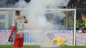Fans throw a flair towards Cremonese's goalkeeper Emil Audero during the Serie A soccer match between Cremonese and Inter in Cremona, Italy, Sunday, Feb. 2026. (Alberto Mariani/LaPresse via AP)