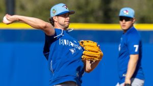 Toronto Blue Jays' Ernie Clement makes a throw to first as Kazuma Okamoto looks on during a drill at spring training in Dunedin, Fla., on Monday, Feb. 16, 2026. (CP/Frank Gunn)