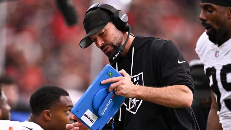 Las Vegas Raiders defensive line coach Rob Leonard reviews a play on an NFL Copilot by Microsoft during the first half of an NFL football game against the Houston Texans, Dec. 21, 2025, in Houston. (AP Photo/Maria Lysaker, File)