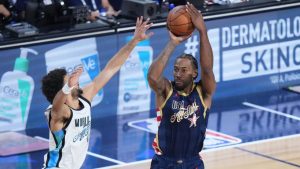 USA Stripes forward Kawhi Leonard (2) shoots over World guard Jamal Murray, of Canada, during the NBA All-Star basketball game Sunday, Feb. 15, 2026, in Inglewood, Calif. (AP Photo/Jae C. Hong)