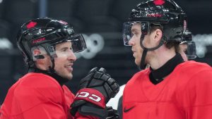 Team Canada captain Sidney Crosby, left, talks with forward Connor McDavid as they take part in practice during the 2026 Milan Cortina Winter Olympics in Milan, Italy on Sunday, February 8, 2026. (Nathan Denette/CP)
