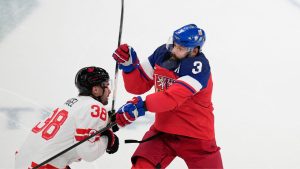 Canada's Brandon Hagel, left, challenges Czechia's Radko Gudas during a preliminary round match of men's hockey between Czech Republic and Canada at the 2026 Winter Olympics, in Milan, Italy, Thursday, Feb. 12, 2026. (AP Photo/Petr David Josek)