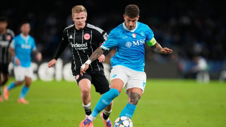 Napoli's Giovanni Di Lorenzo, right, controls the ball by Frankfurt's Hugo Larsson during the Champions League opening phase soccer match between Napoli and Eintracht Frankfurt in Naples, Italy, Tuesday, Nov. 4, 2025. (Gregorio Borgia/AP)