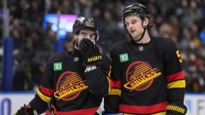 Vancouver Canucks' Conor Garland, left, and Teddy Blueger talk before a faceoff during the third period of an NHL hockey game against the Washington Capitals, in Vancouver, on Wednesday, January 21, 2026. (Darryl Dyck/CP)