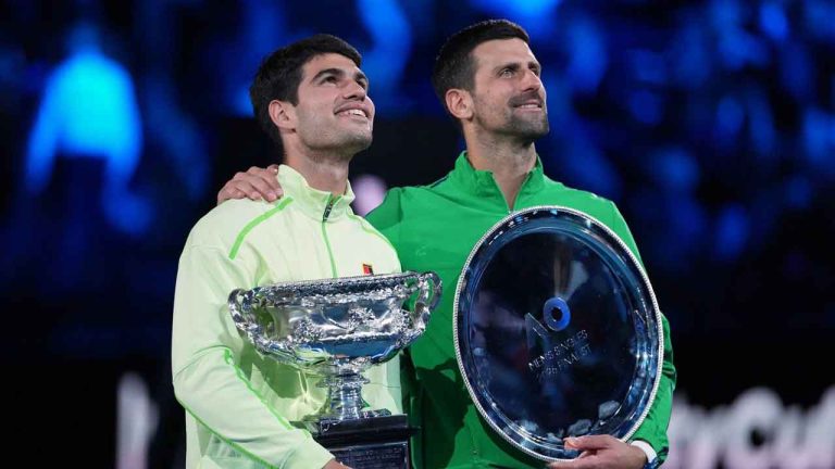 Carlos Alcaraz, left, of Spain holds the Norman Brookes Challenge Cup after defeating Novak Djokovic of Serbia in the men's singles final at the Australian Open tennis championship. (Aaron Favila/AP)