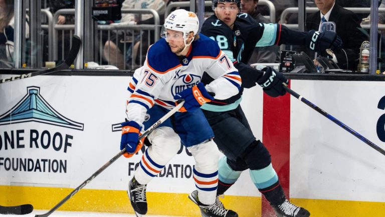 Edmonton Oilers defenceman Alec Regula skates against forward Seattle Kraken Jani Nyman during the second period of an NHL preseason hockey game, Wednesday, Oct. 1, 2025, in Seattle. (Stephen Brashear/AP)