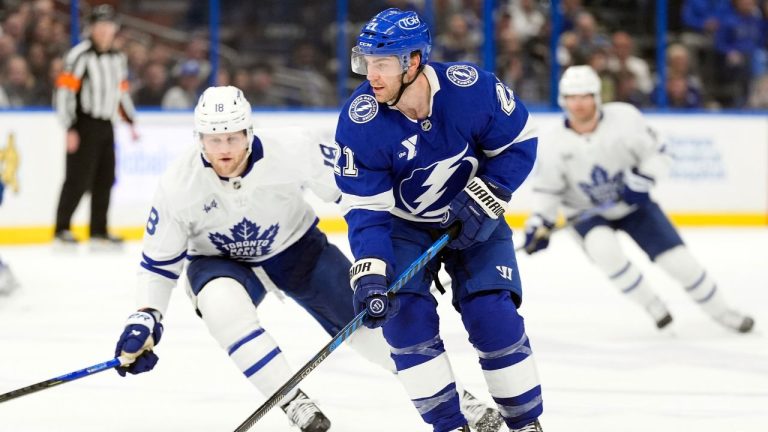 Tampa Bay Lightning centre Brayden Point (21) controls the puck in front of Toronto Maple Leafs forward Steven Lorentz (18) during the first period of an NHL hockey game Wednesday, Feb. 25, 2026, in Tampa, Fla. (Chris O'Meara/AP)