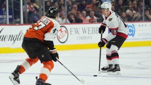 Ottawa Senators' Tim Stützle (18) looks to pass past Philadelphia Flyers' Noah Juulsen during the third period of an NHL hockey game, Thursday, Feb. 5, 2026, in Philadelphia. (Matt Rourke/AP)