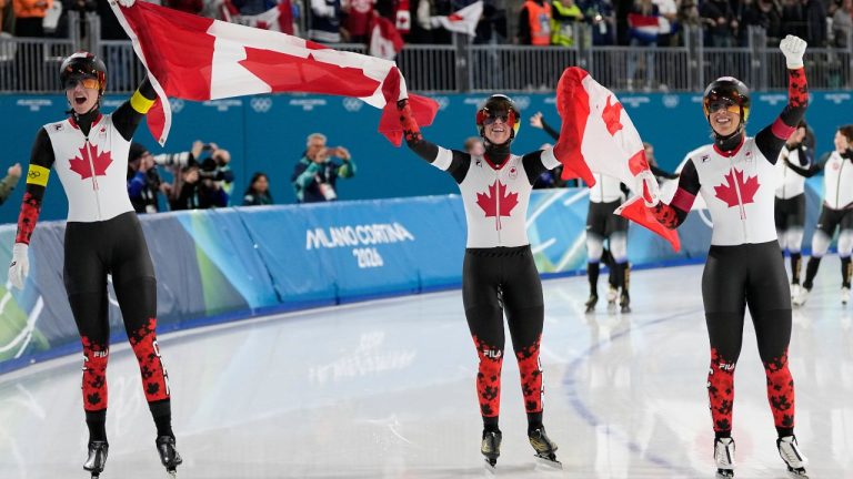 Team Canada with Ivanie Blondin, white armband, Valerie Maltais, red armband, Isabelle Weidemann, yellow armband, celebrate winning the gold medal in the final of the women's team pursuit speedskating race at the 2026 Winter Olympics, in Milan, Italy, Tuesday, Feb. 17, 2026. (Ben Curtis/AP Photo)