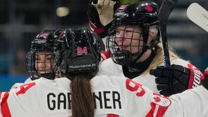 Canada's Kristin O'Neill, left, celebrates after scoring her side's third goal during a preliminary round match of women's ice hockey between Finland and Canada at the 2026 Winter Olympics, in Milan, Italy, Thursday, Feb. 12, 2026. (Hassan Ammar/AP Photo)