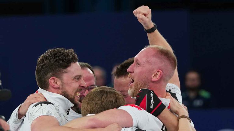 Canada's Brett Gallant, Brad Jacobs, Marc Kennedy and Ben Hebert celebrate defeating Britain in a men's curling gold medal match, at the 2026 Winter Olympics, in Cortina d'Ampezzo. (Misper Apawu/AP)