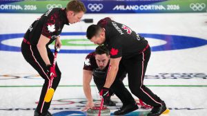 Canada's Brett Gallant, centre, Ben Hebert, right, and Marc Kennedy in action during the men's curling round robin session against Czechia, at the 2026 Winter Olympics, in Cortina d'Ampezzo, Italy, Wednesday, Feb. 11, 2026. (Misper Apawu/AP)
