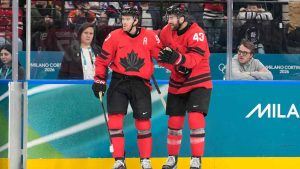 Canada's Connor McDavid (97) celebrates scoring a goal with Canada's Tom Wilson (43) during a preliminary round game of men's ice hockey between Canada and France at the 2026 Winter Olympics. (Hassan Ammar/AP)