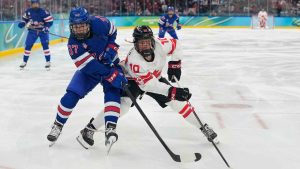 United States' Abbey Murphy (37) challenges with Canada's Sarah Fillier (10) during a women's ice hockey gold medal game between the United States and Canada at the 2026 Winter Olympics. (Hassan Ammar/AP)