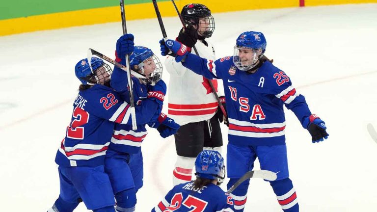 United States' Hilary Knight (21) celebrates a goal with Tessa Janecke (22), Taylor Heise (27) and Alex Carpenter (25) against Canada during the third period of the women's gold medal hockey game at the 2026 Winter Olympics, in Milan. (Nathan Denette/THE CANADIAN PRESS)