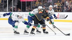 Vegas Golden Knights left wing Ivan Barbashev (49) skates against Vancouver Canucks right wing Conor Garland (8) and left wing Evander Kane (91) during the second period of an NHL hockey game Wednesday, Feb. 4, 2026, in Las Vegas. (Ian Maule/AP)