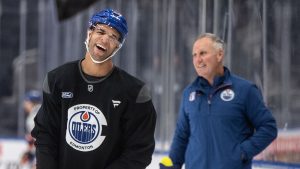 Edmonton Oilers' Darnell Nurse (25) has a laugh with assistant coach Paul Coffey during practice before Game 1 of the Stanley Cup final against the Florida Panthers, in Edmonton on Tuesday, June 3, 2025. (Jason Franson/CP)