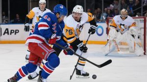 New York Rangers' Conor Sheary (43) fights for control of the puck with Pittsburgh Penguins' Connor Clifton (75) during the first period of an NHL hockey game Saturday, Feb. 28, 2026, in New York. (Frank Franklin II/AP)