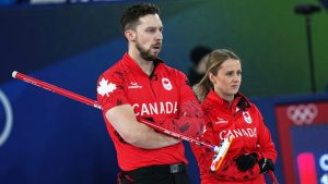 Canada's Brett Gallant, left, and Jocelyn Peterman compete during the mixed doubles round robin phase of the curling competition against Estonia at the 2026 Winter Olympics, in Cortina d'Ampezzo, Italy, Saturday, Feb. 7, 2026. (Fatima Shbair/AP)