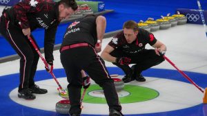 Canada's Brett Gallant, Marc Kennedy, and Ben Hebert in action during the men's curling round robin session against Sweden, at the 2026 Winter Olympics, in Cortina d'Ampezzo, Italy, Friday, Feb. 13, 2026. (Misper Apawu/AP Photo)
