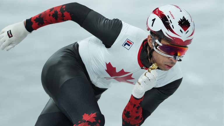 Canada’s William Dandjinou competes in the men's 1,000 metre short track speedskating heats at the 2026 Winter Olympics, in Milan, on Tuesday, February 10, 2026. (Darryl Dyck/THE CANADIAN PRESS)