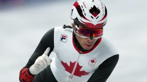Canada's William Dandjinou celebrates his win while competing in the men's 1,000 metre short track speedskating quarterfinals at the 2026 Winter Olympics, in Milan, on Thursday, February 12, 2026. (Darryl Dyck/THE CANADIAN PRESS)